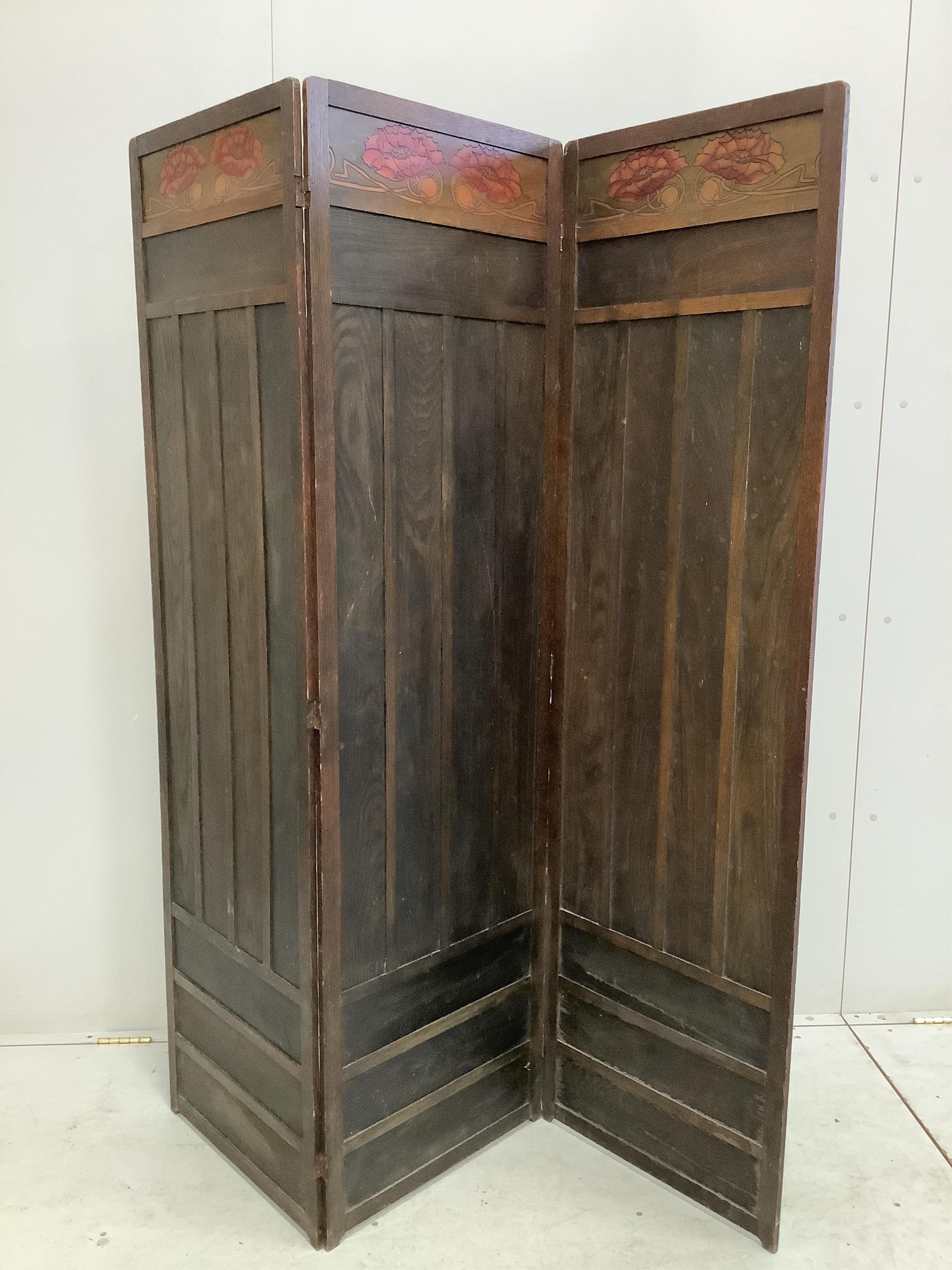 A Liberty & Co. Arts & Crafts pokerwork oak three fold dressing screen, each panel width 50cm, height 174cm. Condition - fair